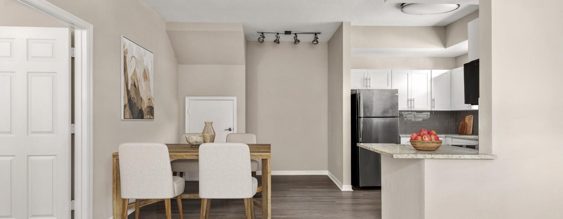 a kitchen with a dining table and chairs